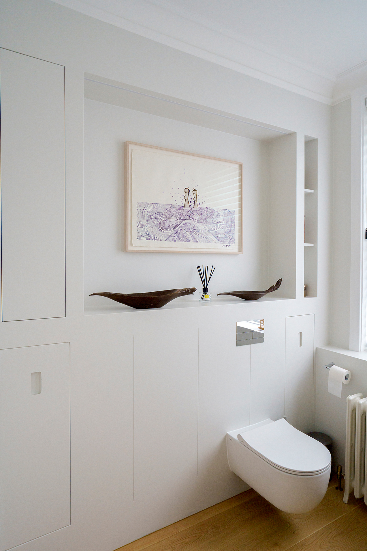 Restored Victorian fireplace within a calm residential interior by Beacham Architects, featuring bespoke joinery, soft neutral walls, and refined heritage detailing in a London home.