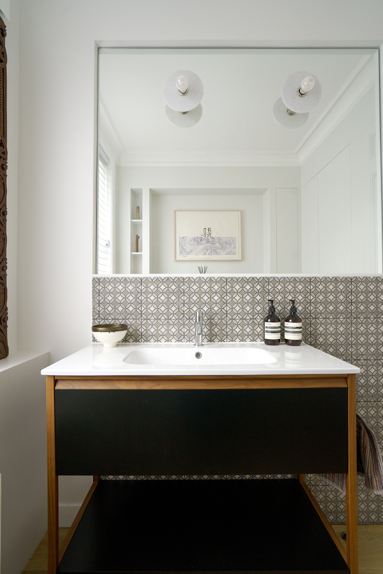 Bespoke bathroom vanity by Beacham Architects featuring patterned tile splashback, minimalist basin, warm timber detailing, and soft neutral tones in a London residential renovation.