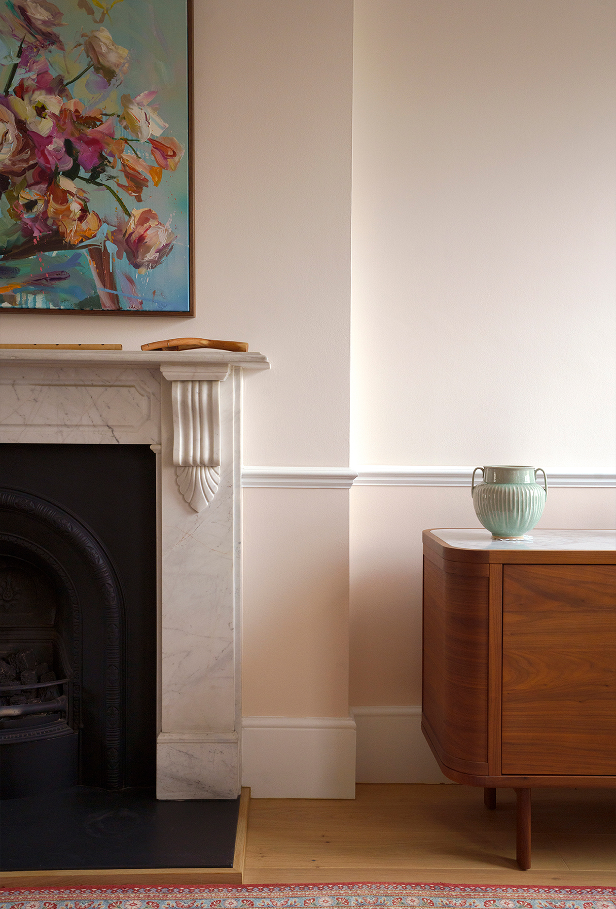 Restored Victorian fireplace within a calm residential interior by Beacham Architects, featuring bespoke joinery, soft neutral walls, and refined heritage detailing in a London home.