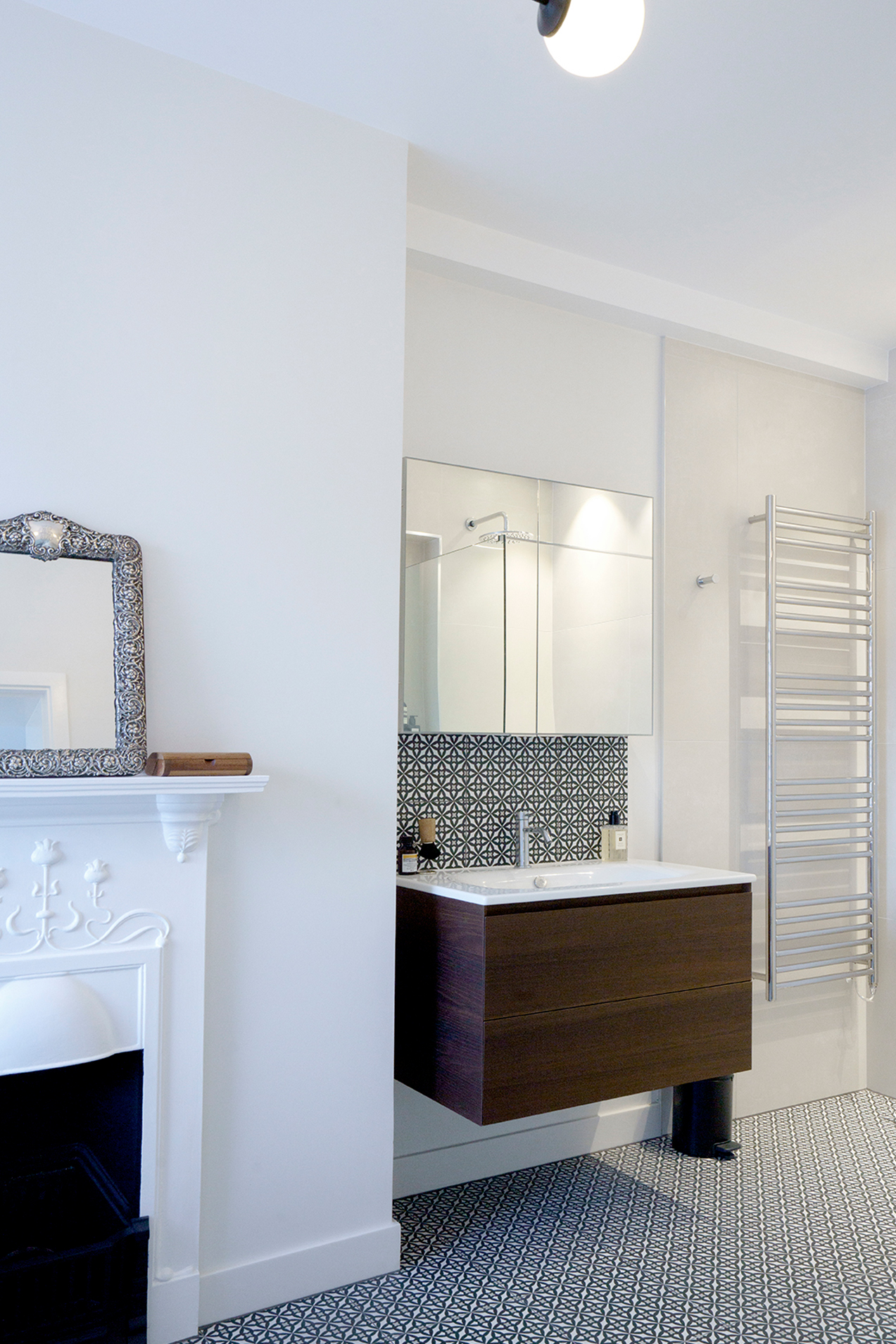 Bespoke bathroom vanity by Beacham Architects featuring patterned tile splashback, minimalist basin, warm timber detailing, and soft neutral tones in a London residential renovation.