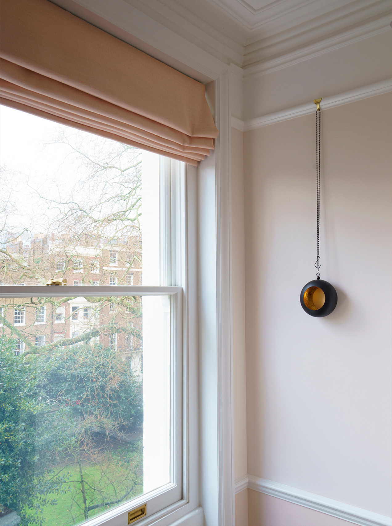 Restored Victorian fireplace within a calm residential interior by Beacham Architects, featuring bespoke joinery, soft neutral walls, and refined heritage detailing in a London home.