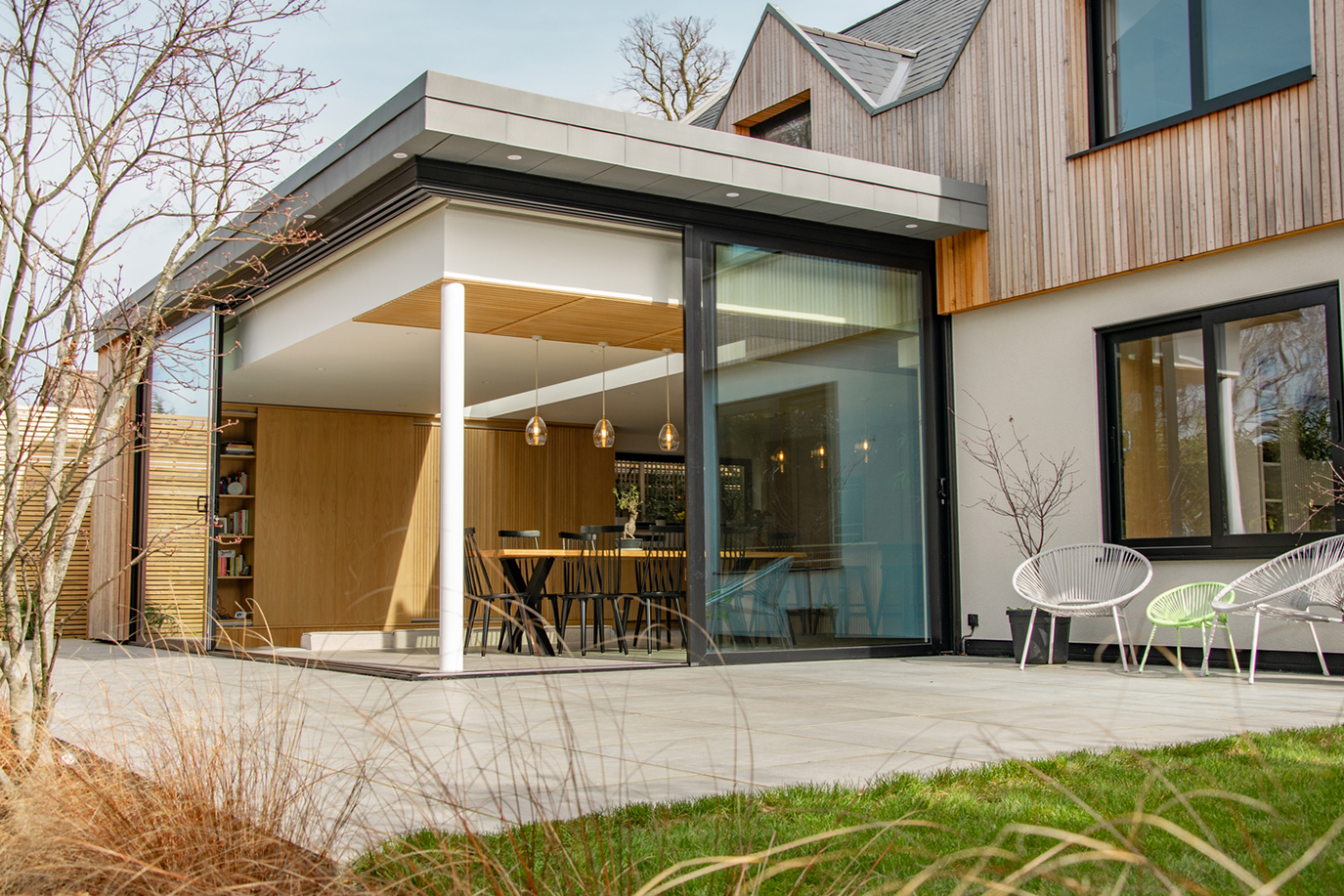 Contemporary residential house designed by Beacham Architects, featuring timber-clad pitched roofs, dormer windows, and a modern reinterpretation of a traditional London home.
