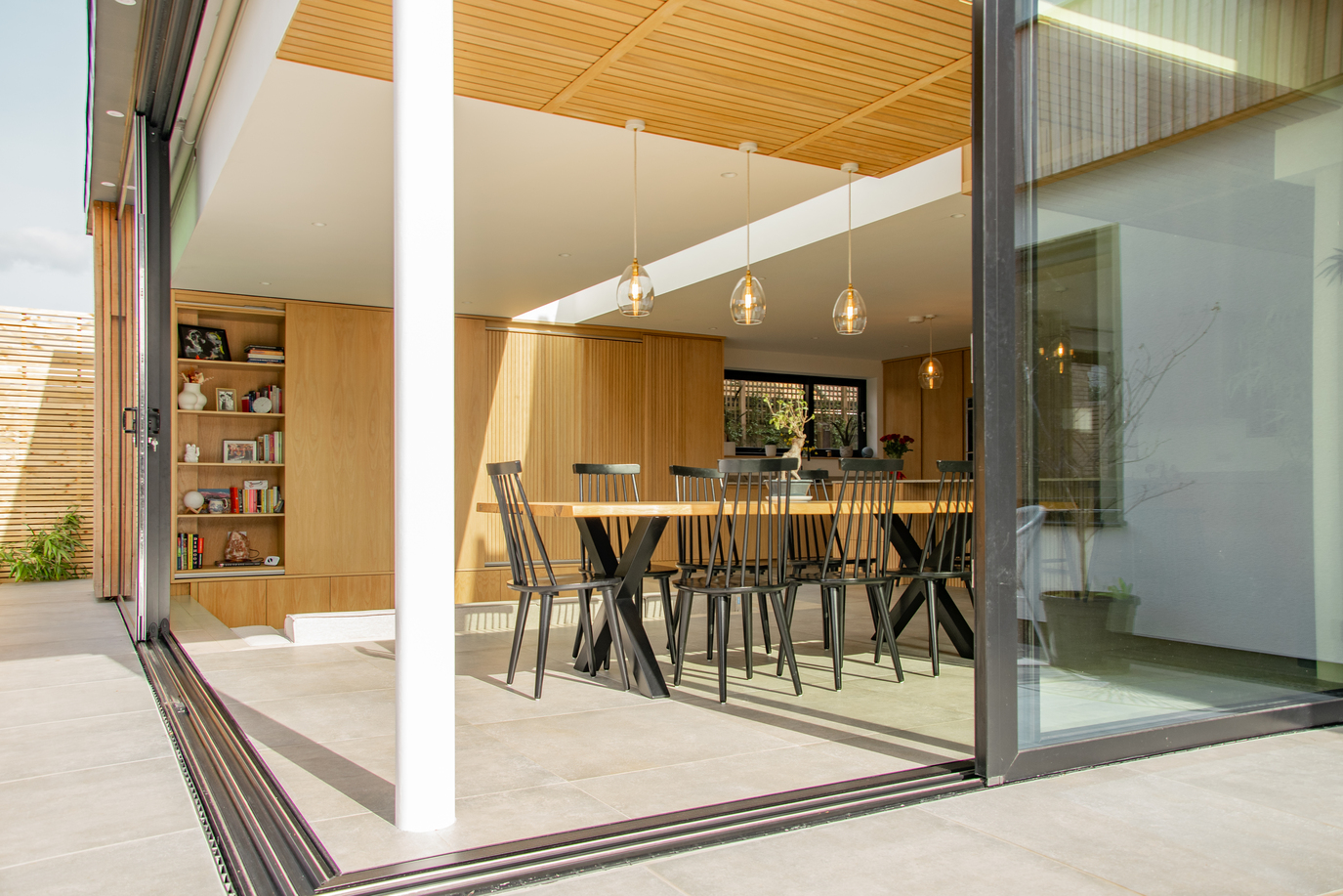 Contemporary residential house designed by Beacham Architects, featuring timber-clad pitched roofs, dormer windows, and a modern reinterpretation of a traditional London home.