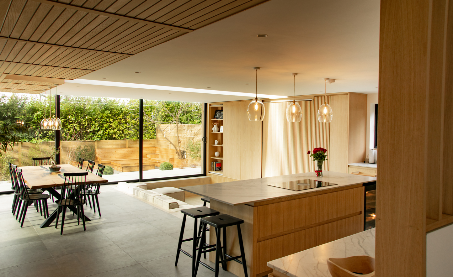 Contemporary residential house designed by Beacham Architects, featuring timber-clad pitched roofs, dormer windows, and a modern reinterpretation of a traditional London home.
